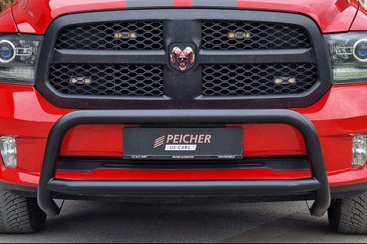 Closeup of a red Dodge Ram with a black bullbar