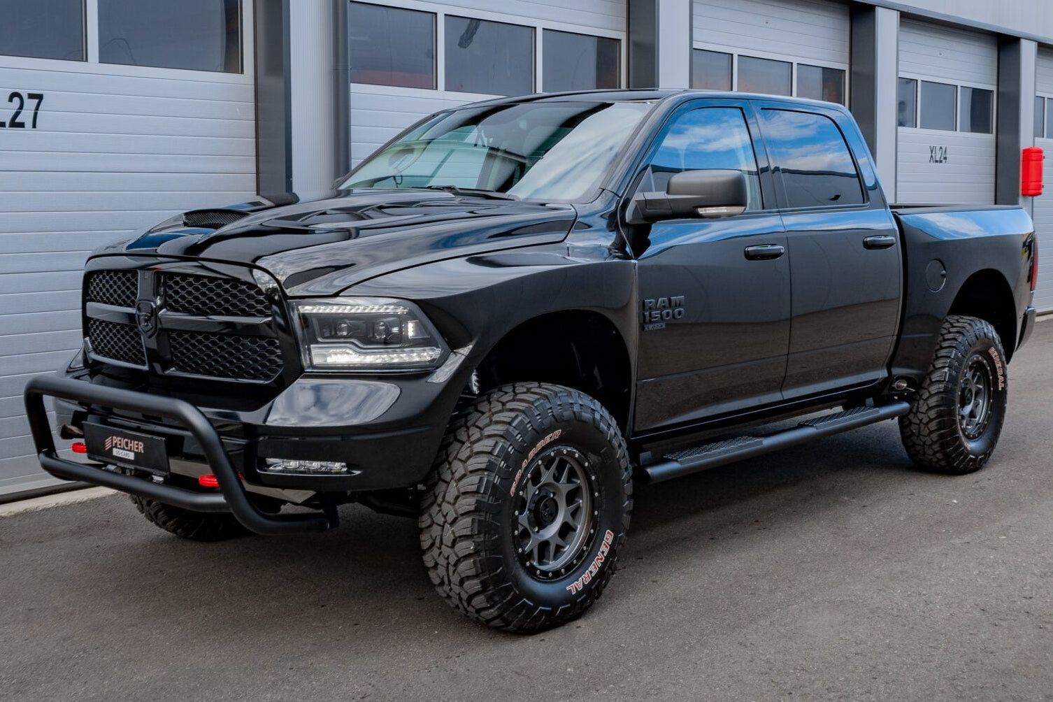 Lifted Dodge Ram with a black bullbar and big offroad tires