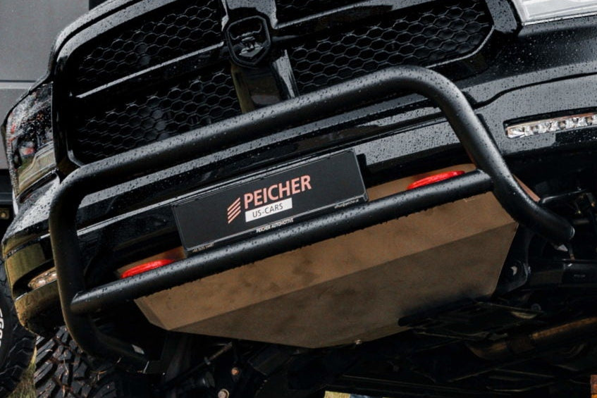 Zoomed in image of a bullbar fitted to a black Dodge Ram with a skid plate