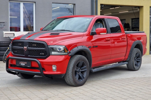 Red Dodge Ram with a black bullbar and black sidesteps