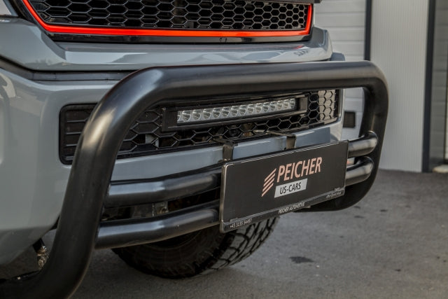 Closeup of a black bullbar fitted to a grey Ford F150