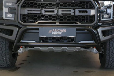 Closeup of a black bullbar fitted to a black Ford F150 Raptor