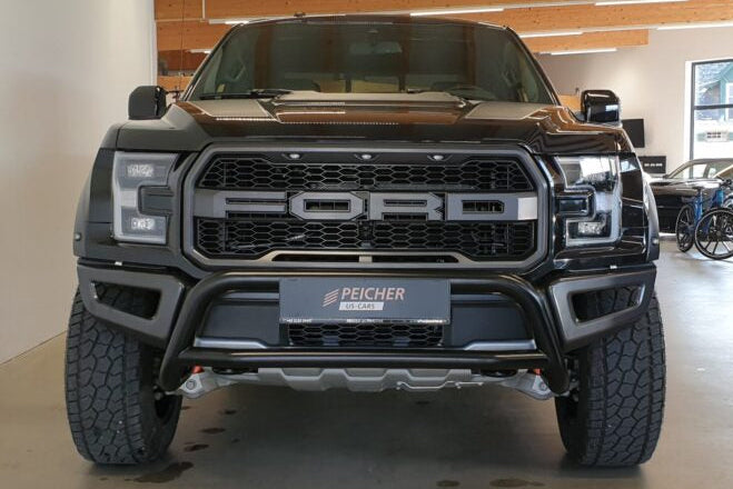 Front view of a black Ford F150 Raptor with a black bullbar