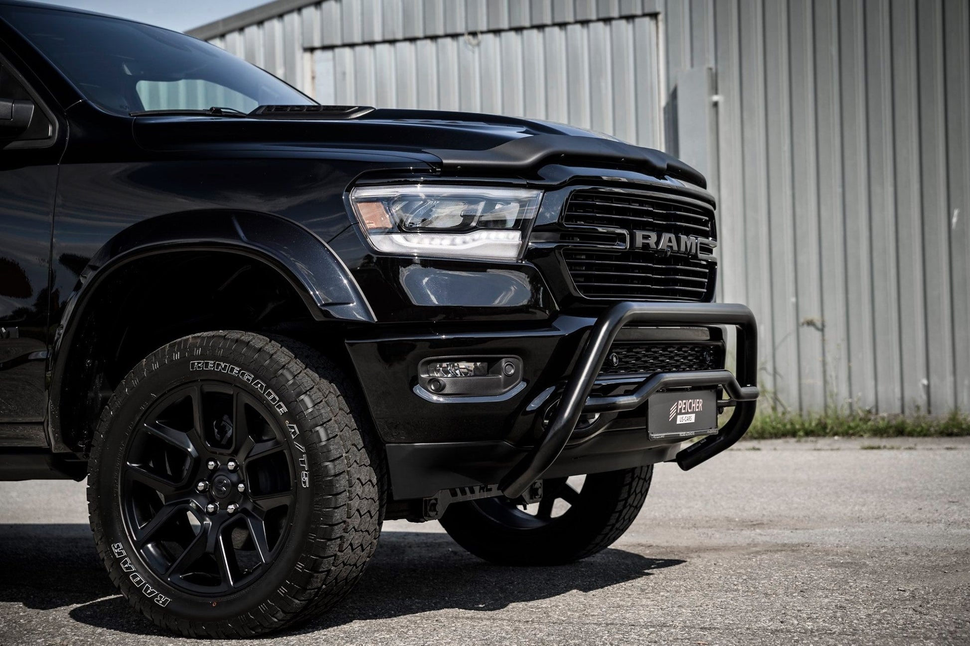 Black Dodge Ram truck with a black bullbar and offroad tires