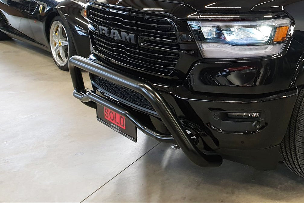 Black Dodge Ram with black bullbar sitting in a showroom