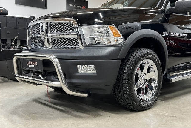 Zoomed image of a black Dodge Ram with a stainless steel bullbar