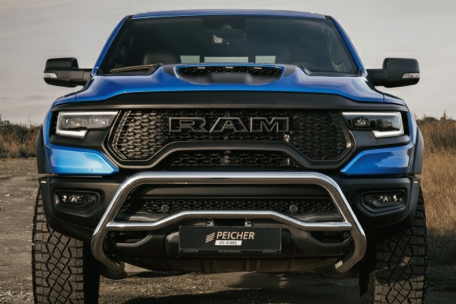 Frontal view of a blue Dodge Ram TRX with a stainless steel bullbar