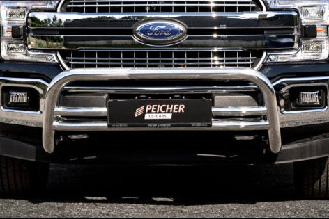 Closeup of a gen. 13 Ford F150 with a stainless steel bullbar