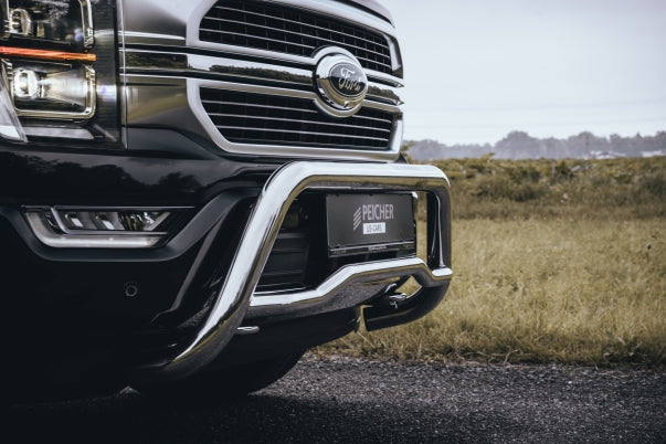 Side view of a stainless steel bullbar on a black Ford F150