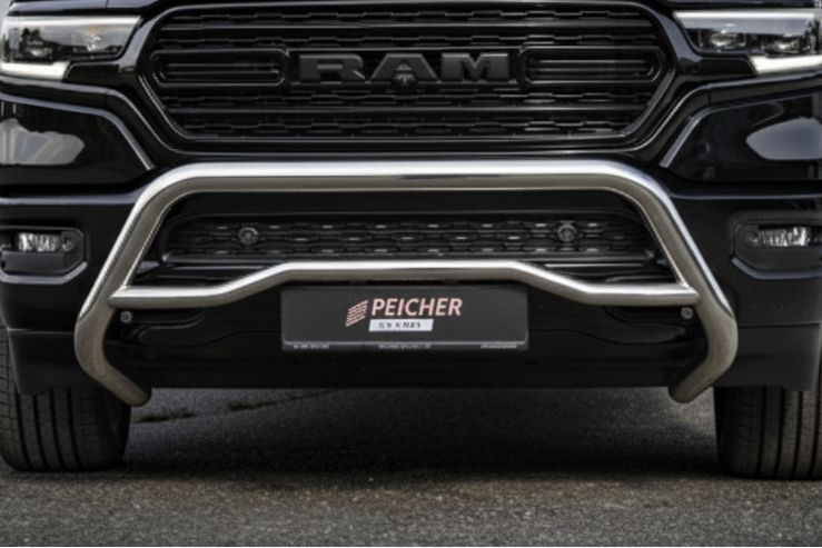 Close-up of a Dodge Ram truck with a stainless steel bullbar on a dark background